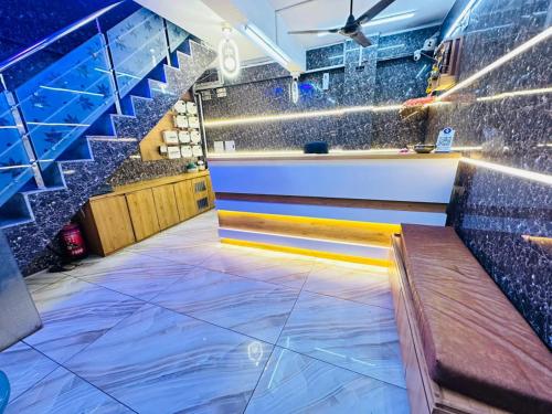 a bar with a counter and stairs in a room at Hotel RR Palace in Rajkot