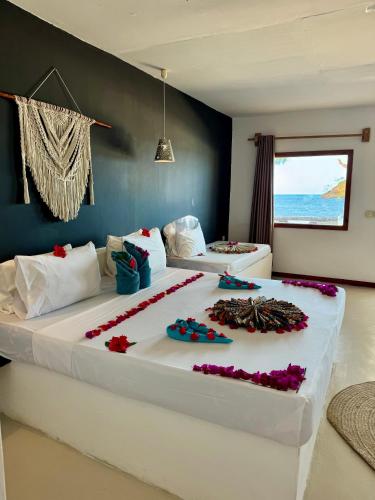 a large bed with flowers on it in a room at AVO Boutique Hotel in Dikoni