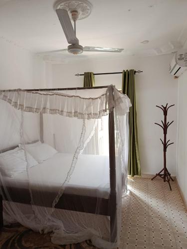 a bedroom with a bed with a canopy at Diani family friendly in Diani Beach