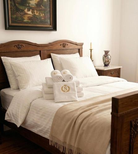a bedroom with a bed with towels on it at Pałac Przybyszewo in Przybyszewo