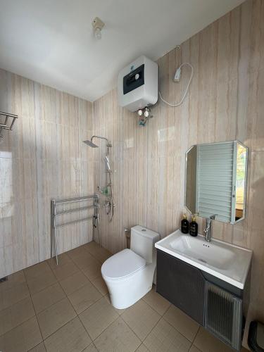 a bathroom with a toilet and a tub and a sink at Glamping Grand Mazaya Private Pool in Bandung