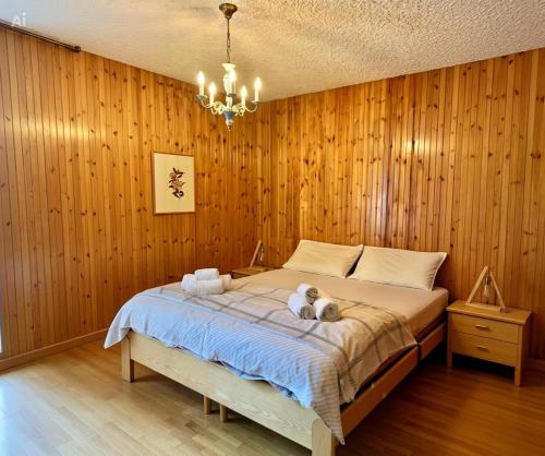 a bedroom with a bed with two stuffed animals on it at Chalet Costa Rotian in Commezzadura