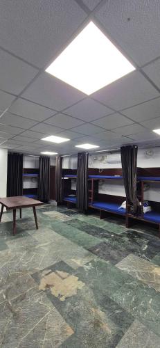 a room with a table in the middle of a room at Chandra Dormitory in Varanasi
