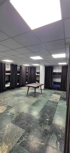 an empty room with a table in the middle of it at Chandra Dormitory in Varanasi