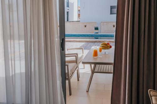 a room with a table and a view of a balcony at Villa Anida in Ulcinj