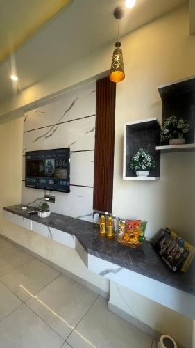 a kitchen with a counter top with a microwave at Tehzeeb living in Lucknow