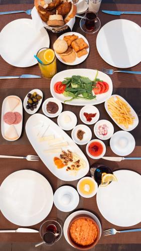 a table topped with plates and bowls of food at Mia Casa Hotel in Fethiye