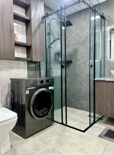 a washing machine in a bathroom with a shower at Amber Nest Tsaghkadzor in Tsaghkadzor