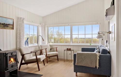 a living room with a table and a fireplace at 3 Bedroom Cozy Home In Haderslev in Haderslev