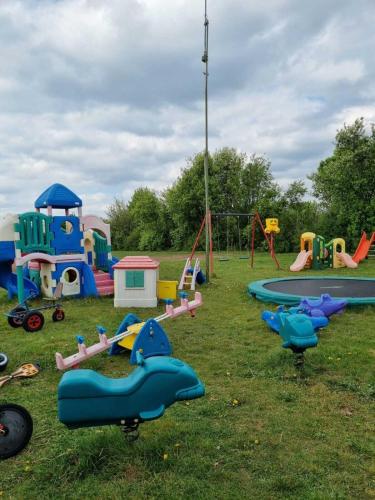 a playground with many different types of play equipment at Camping Amable in Someren-Heide