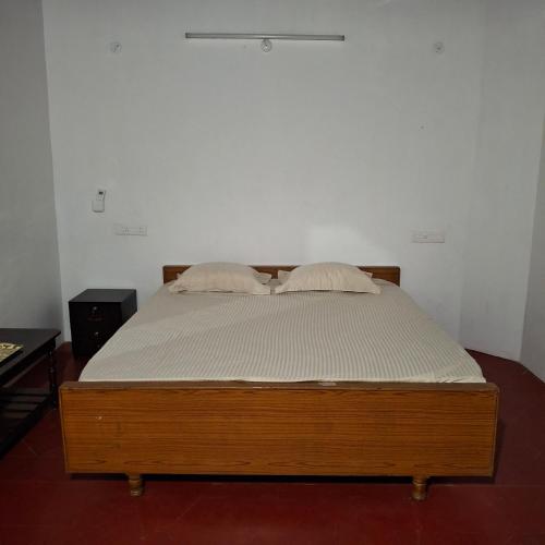 a bed with two pillows on it in a room at Umbrella Guest House - Palace Suite in Madurai