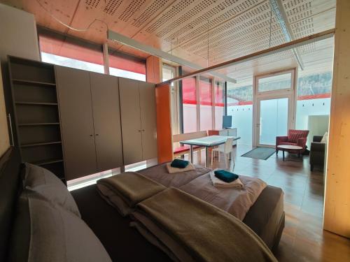 a bedroom with a bed and a table in a room at Chalet Tschallener in Ried im Oberinntal