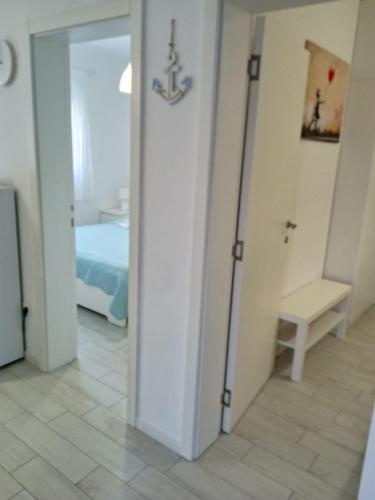 a room with a door leading to a bedroom at Apartments Zlata in Lopar