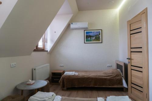 a small room with a bed and a window at Guest House MARGARYAN in Yerevan
