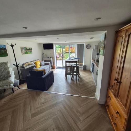 a living room with a couch and a table at Cwtch on The meadow in Abergavenny