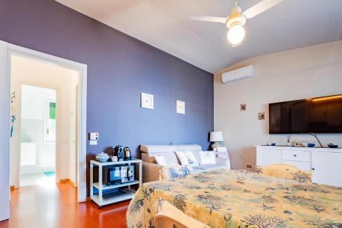 a bedroom with a bed and a blue wall at Moneglia - Le Case di Bart in Moneglia