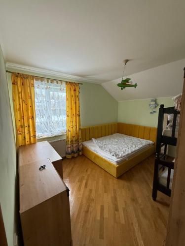 a small bedroom with a bed and a window at БУДИНОК сімейних ПРИГОД in Vodniki