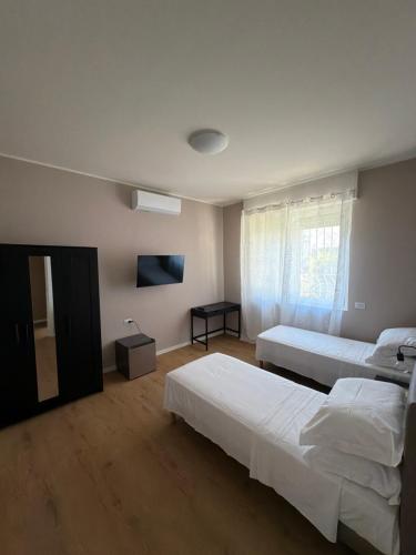 a bedroom with two beds and a window at 88 Destination in Treviglio