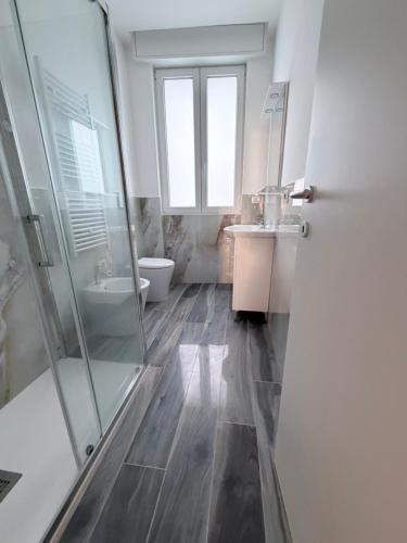 a bathroom with a shower and a toilet and a sink at 88 Destination in Treviglio