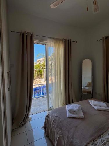 a bedroom with a bed and a large window at Seana Hidden Gem in Kapparis in Paralimni
