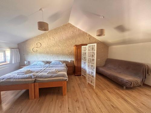a bedroom with a bed and a bench in it at B&B Angueur in Montrem
