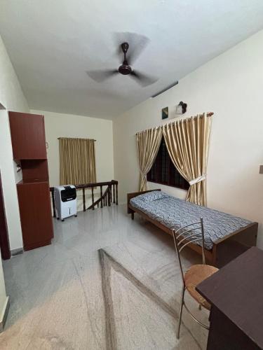 a living room with a couch and a bed at Stay at Renovated Home at DBRA-61 Don Bosco Cross Road Vaduthala Ernakulam in Cochin