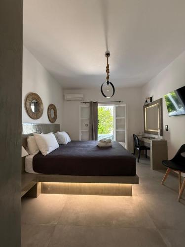 a bedroom with a large bed and a desk at Zoumis Residence in Naousa