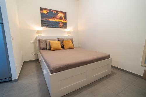 a bed with two pillows on it in a room at NOVELLA DEL MAR prima fila dal mare in Grottammare