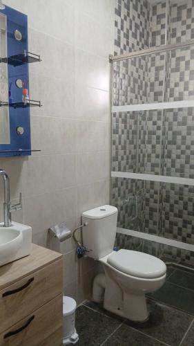 a bathroom with a toilet and a sink at Palm Serenity in Tangier
