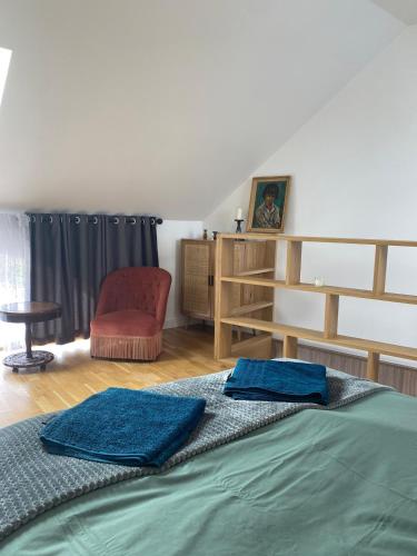 a bedroom with a bed and a chair and a desk at Charmant petit maison in Pontorson