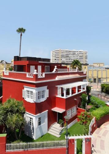a red and white house with a street at Deluxe Coliving Islas Canarias in Las Palmas de Gran Canaria