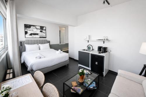 a hotel room with a bed and a table at The Athenian Pearl in Athens