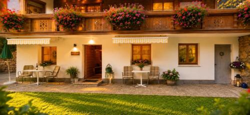 a house with a patio with tables and chairs at Ferienwohnung in Itter bei Söll SkiWelt Wilder Kaiser Kitzbüheler Alpen ITD100 in Itter
