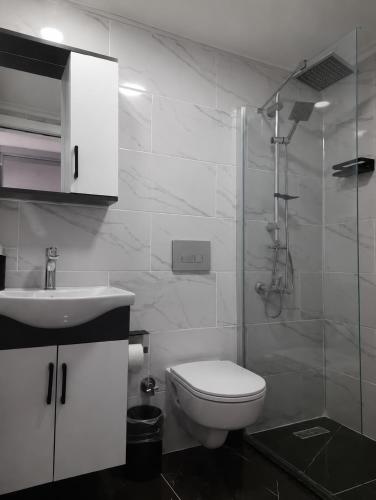 a bathroom with a toilet and a sink and a shower at Hotel Efesian B&B City Center - Harbour in Kuşadası