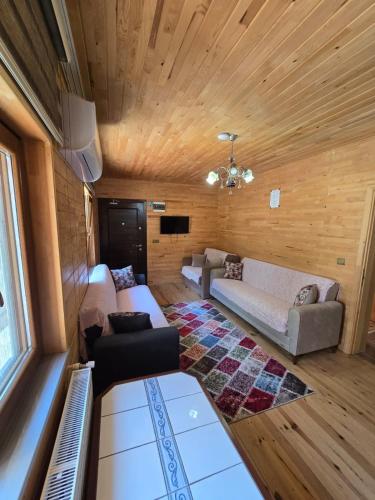 a living room with a couch and a table at Katipogulları Apart in Uzungöl