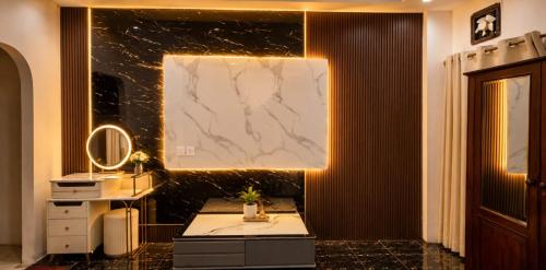 a bathroom with a vanity and a marble wall at YT Hotel & Hostel Vientiane in Vientiane