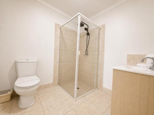 a bathroom with a shower with a toilet and a sink at Pet Friendly close to Mooloolaba Sleeps 6 in Mountain Creek