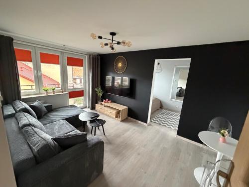 a living room with a couch and a table at Apartament Staropijarska in Łuków