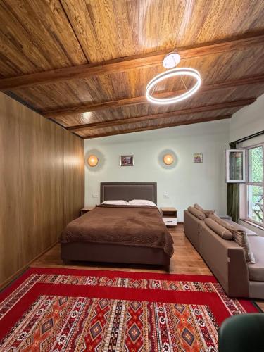 a bedroom with a bed and a couch at Private in Shchūchīnsk