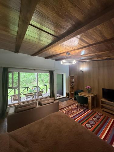 a bedroom with a bed and a couch and a table at Private in Shchūchīnsk