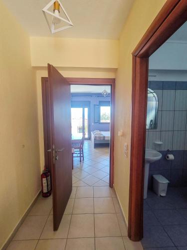a hallway with a door leading to a bathroom at Lavender Apartments in Skala Potamias