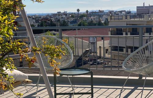 two chairs and a table on a balcony at Blue Loft 360 in Patra