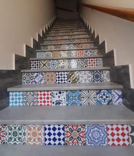 a set of stairs with different tiles on them at Coccodrillo Fiorito in Viareggio