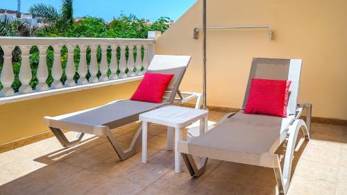two chairs and a table on a balcony at Primavera apartment with heated pool in Palm-Mar