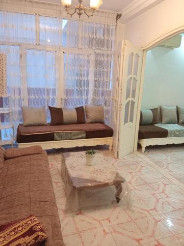 a living room with a couch and a table at Oran ville in Oran
