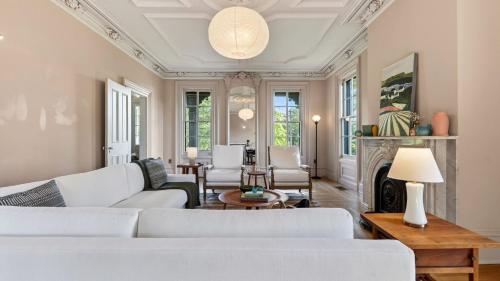 a living room with white furniture and a fireplace at River View by AvantStay in Germantown