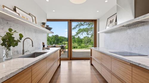 a kitchen with two sinks and a large window at River View by AvantStay in Germantown