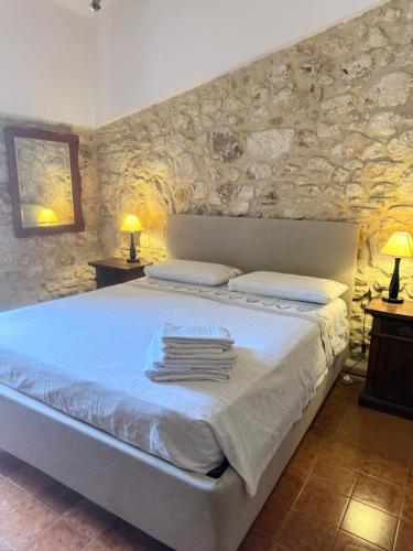 a bedroom with a bed with towels on it at Asparano in Ognina