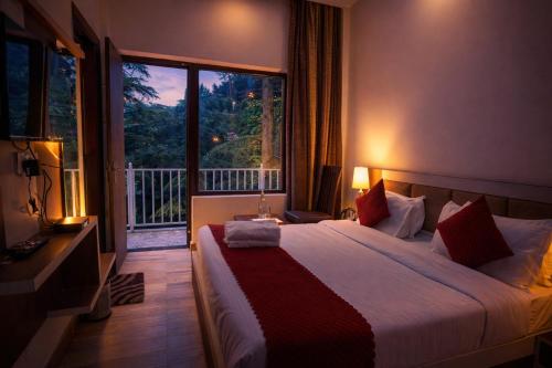 a bedroom with a large bed and a large window at Dalhousie Hotel in Dalhousie