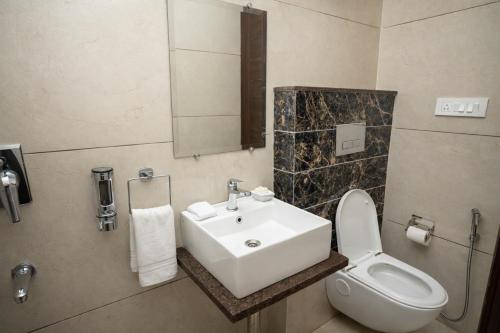 a bathroom with a sink and a toilet at Dalhousie Hotel in Dalhousie